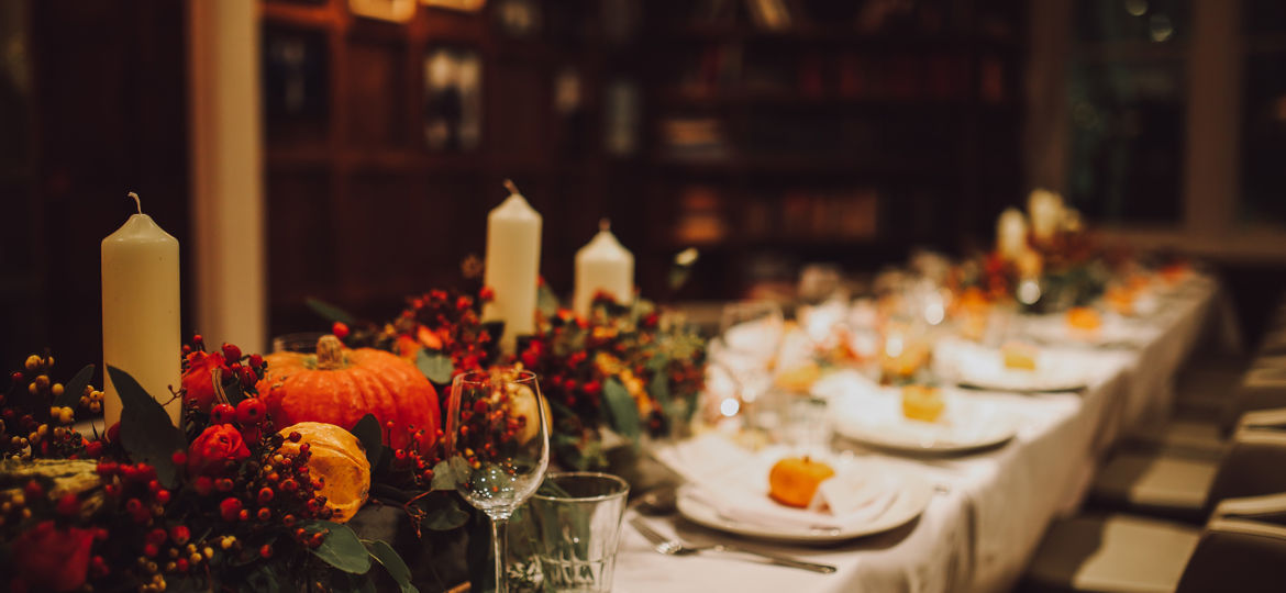 Thanksgiving table setting with automnal decorations, pumpkins,